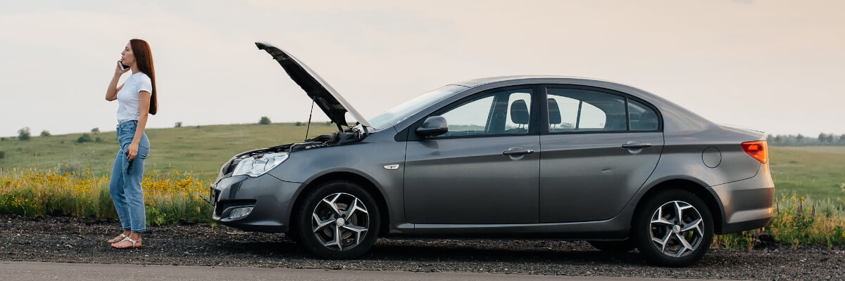 A broken down car with an angry customer calling roadside assistance